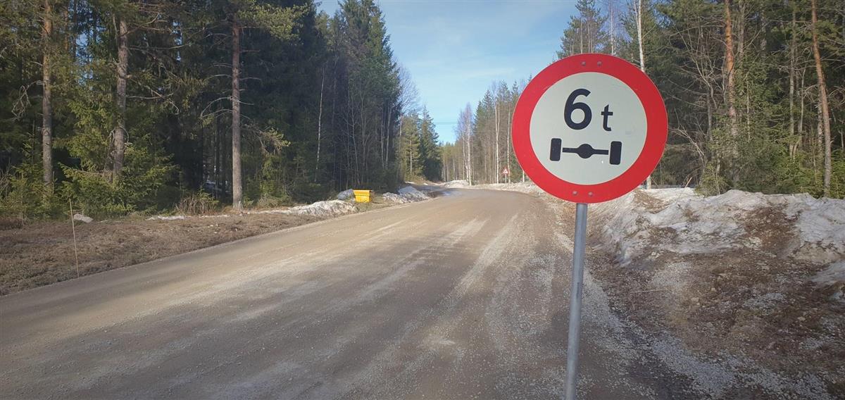 Skilt som viser telerestriksjon med maks aksellast på seks tonn. Grusveg i bakgrunnen. - Klikk for stort bilde